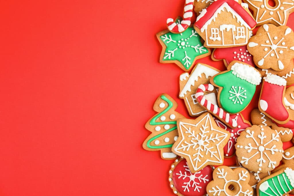 Tasty homemade Christmas cookies on color background, top view